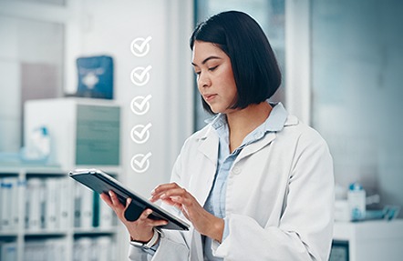 Two pharma technicians working together with a tablet in a pharma lab set-up.